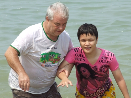 Helping a young blind woman experience the warm waters of the Gulf of Thailand for the very first time.