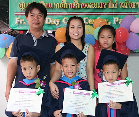 Two very proud parents of three young brothers.