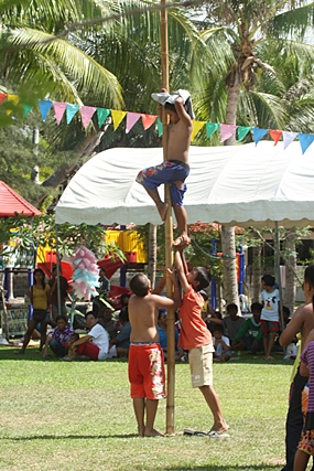 Some of the youngsters become extra resourceful, trying to reach the 500 baht at the top of the greased pole.