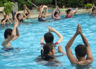 Expecting mothers and their families take part in hydrotherapy exercises at the Diana Garden Resort pool.