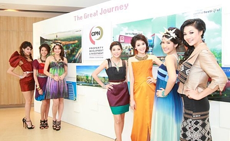 Models stand next to a billboard showing CPN’s new retail development projects for 2012-13.