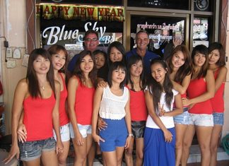 Andy Oz and Tony Cowe (standing rear) pose with the staff outside Blue Sky Bar.