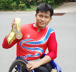 Supachai Koysub shows a selection of his winning medals from previous Olympic Games.