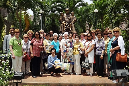 Everyone gathers for a photograph in front of Father Ray’s statue, the beloved father and founder of the Pattaya Orphanage.