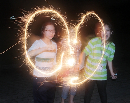 Campers making shapes with sparklers during the evening activity.