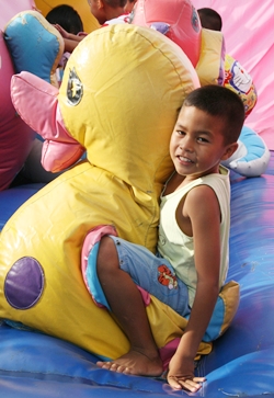 All the children have lots of fun on the bouncy castle.