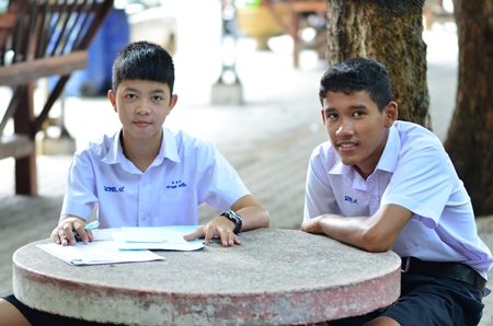Bodhisamphan students Sarayut Maneechuen (left) and Nathwut Nuanphulb (right) do some of their homework outside in the fresh air.