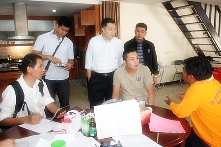 Police investigators interrogate alleged ringleader Liu Jian (seated, center) from Anhui, China. 