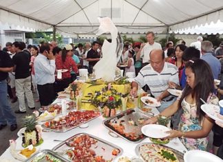 Guests dig in to the delicious food and wine laid out for the occasion.