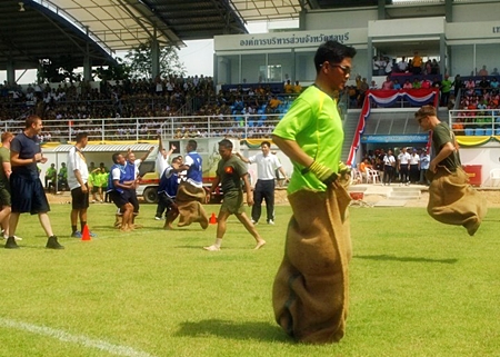 Royal Thai and U.S. Service members compete in a sack race during a joint sports day event for Cooperation Afloat Readiness and Training (CARAT) Thailand 2012. (U.S. Navy photo by Mass Communication Specialist 1st Class Robert Clowney/Released)