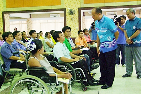 Gov. Khomsan Ekachai talks with disabled residents at Chalerm Prakiet Pavilion in Chonburi. 