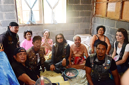 Chaiyos Chaloawanarat, leader of the Yo Middle Way motorcycle club and a handful of bikers visit the stricken family. 