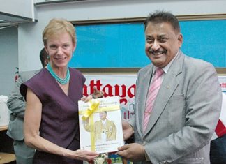 Pattaya Mai MD Peter Malhotra (right) presents a copy our book about HM the King’s birthday to HE Kristie Kenney, U.S. Ambassador to Thailand.