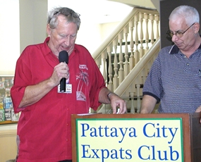 Member ‘Hawaii Bob’ awards the prizes of discounts & ‘2 for 1’s at Pattaya area restaurants to many PCEC members. MC Richard Silverberg looks on.