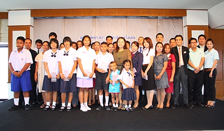 Hotel Assistant General Manager Sompong Wattana (center, green dress) presents 27 scholarships worth 98,500 baht to hotel employees for their children. 