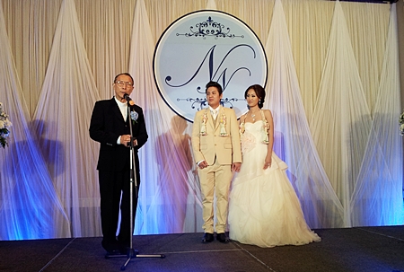 Father Michael Weera Phankrak gives the happy couple his best wishes on their way. 