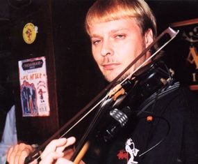 A portrait with the face in focus and the hand out of focus.