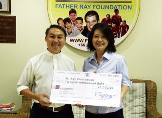 Vanvara Supongspun (right) presents a cheque for 25,000 baht to Father Pattarapong in aid of the Father Ray Foundation. The funds were raised at a recent party held at the Vanvaras German School located on Sukhumvit Road in Pattaya.