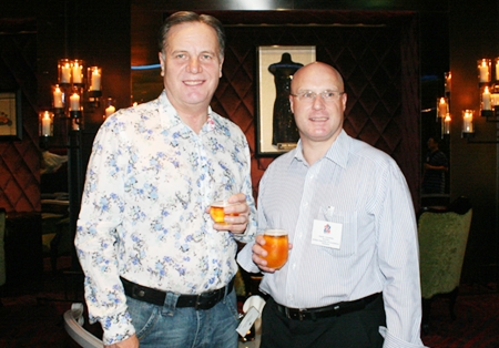 Simon Matthews (country manager for Thailand Manpower Group) and David Cumming (director of BCCT) sip some amber liquid together.