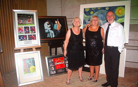 Adele Pickles, Tracy Cosgrove and Andrew Pickles display some of the items up for auction, all paintings supported by Peter Banner..