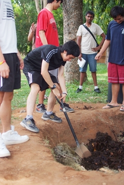 Students digging compost.