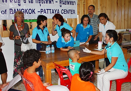 Dr. Natnicha Loichuen, specialist medical professional and member of YWCA Bangkok-Pattaya Center, provides check-ups for the kids.