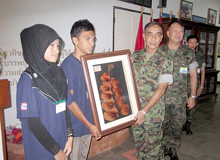  Rear Adm. Wetveera Throngworawith presents the children with a keepsake to take back to their school. 