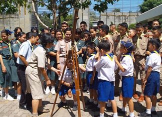 Students in Sattahip gather to watch Venus transit the sun.