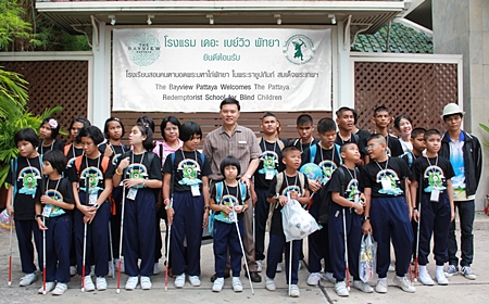 Nijjaporn Marprasert (center) welcomes young blind students to the Siam Bayview Hotel. 