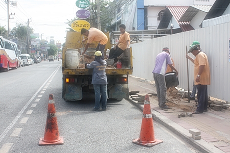 City workers repair a portion of sidewalk on Second Road in North Pattaya. 