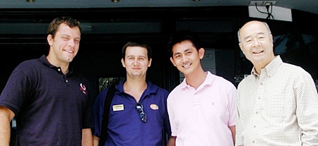 Mechai on the right, poses with staff Nut, Michael, and Tristan (left) of the Mechai Pattana School. 