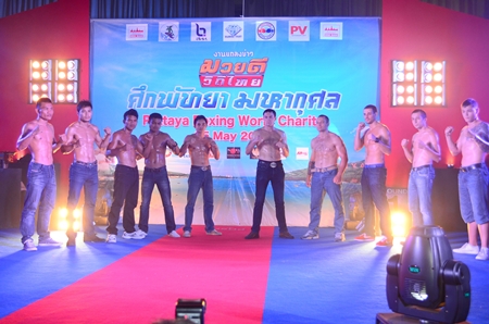 Thai and Russian Muaythai fighters pose for photos at a press conference held May 25 to announce the charity boxing event. 