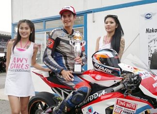 Benn Fortt, center, poses with his trophy after winning the second round of the SB2 Superbike 1000cc Thailand Championship at Nakon Chaise racetrack.