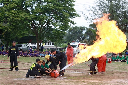 Students learn how to contain a gas tank spewing flames. 