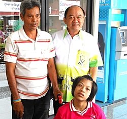 We provided Paew, a 14-year-old girl crippled from birth, with a bigger wheelchair, along with her ration of rice and milk. Her father stands on the left, next to the deputy mayor of Nongprue.