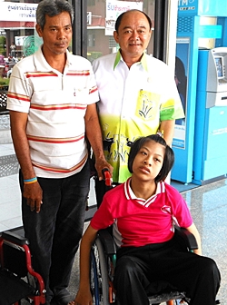 We provided Paew, a 14-year-old girl crippled from birth, with a bigger wheelchair, along with her ration of rice and milk. Her father stands on the left, next to the deputy mayor of Nongprue.