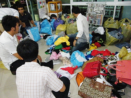 Copyright police sort through piles of counterfeit garments. 