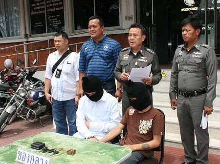 Pol. Col. Somnuk Changate (2nd right) brings out the 2 underage boys, part of a gang that robbed a policeman’s condo. 