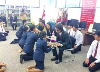 Students representatives present flowers to their teachers as a show of respect during the wai khru ceremony.