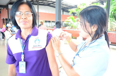 “You may feel a little pinch…” A nurse vaccinates a woman against the flu during the preventative-health fair.
