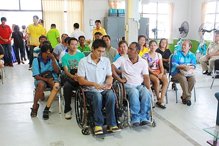Disabled Chonburi residents listen as Ruangpit Kankulwot lectures on how to make flowers from gossamer and paper. 