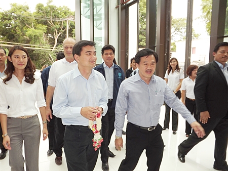 Former Prime Minister Abhisit Vejjajiva arrives at Cape Dara Resort in Naklua with Surat Mekarawarakul, CEO of Mike Group. 