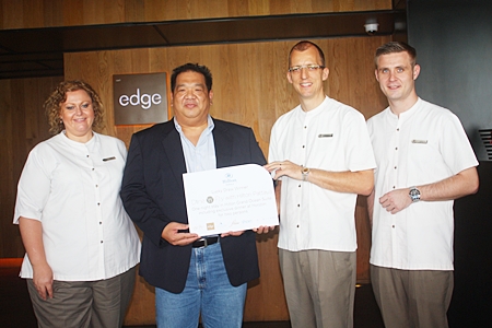 Hilton Pattaya General Manager Harald Feurstein (2nd right) presents the prize to winner Anucha Pingkarawat (2nd left) as Peta Ruiter (left), Hilton’s director of business development and Simon Bender (right), food and beverage manager look on.