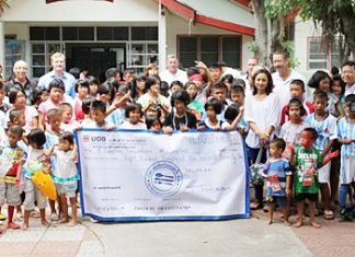 Members of the organising committee for the Camel Summer Charity Classic of 2012 present a cheque for THB 800,170 to the children and coordinators of the Camillian Social Center in Rayong.