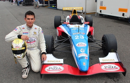 Sandy Stuvik poses next to his Formula Renault racecar at the Oschersleben Circuit in Germany.