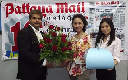 Tony Malhotra, Asst. MD of the Pattaya Mail Media Group receives a bouquet from Usa Pookpant, PR manager and Wirasinee Kaewkeeree, PR executive of Centara Grand Mirage Beach Resort Pattaya to congratulate us on our recent 19th anniversary.
