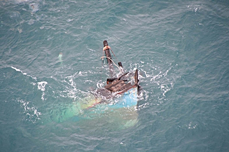 The tip of the bow is all that’s visible of the sunken vessel. 
