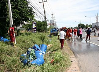 Firefighters hose down Sukhumvit Road to disperse about 200 liters of n-butyl chloride spilt in the accident.