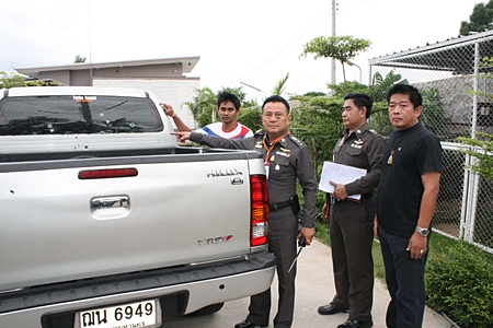 Wuthipan Krajuikrajai (left) shows Pol. Col. Somnuk Changate and other police officials damage done to his pickup from the late night barrage of gunfire. 