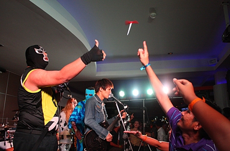 Fans rake up gifts thrown from stage.